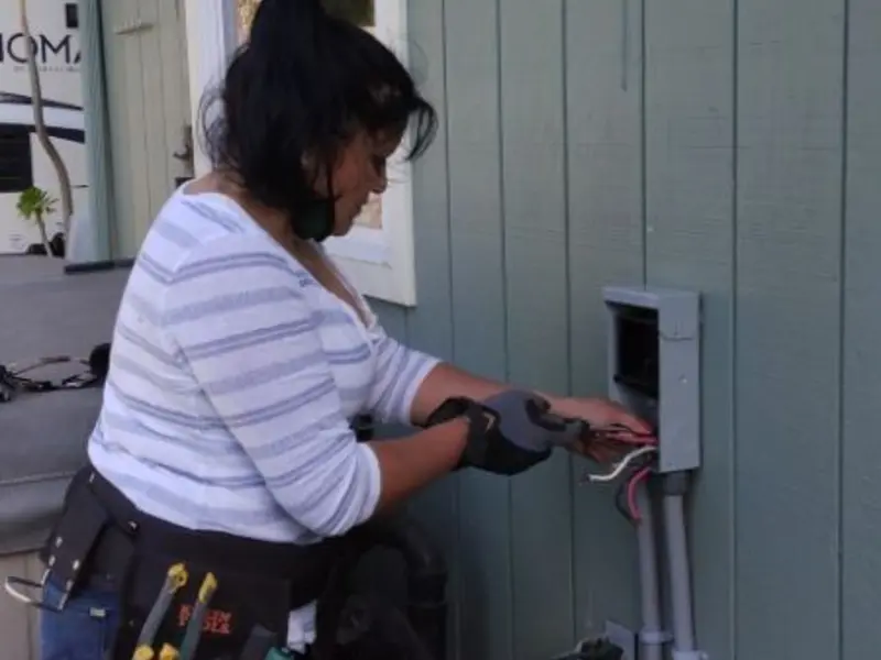 Licensed electrician wiring an exterior subpanel in Elkins