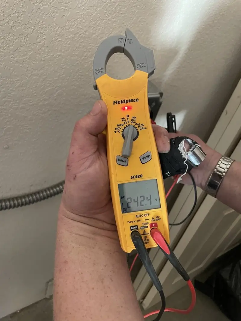 Voltage testing with clamp meter during Electrical Installation Services in Elkins
